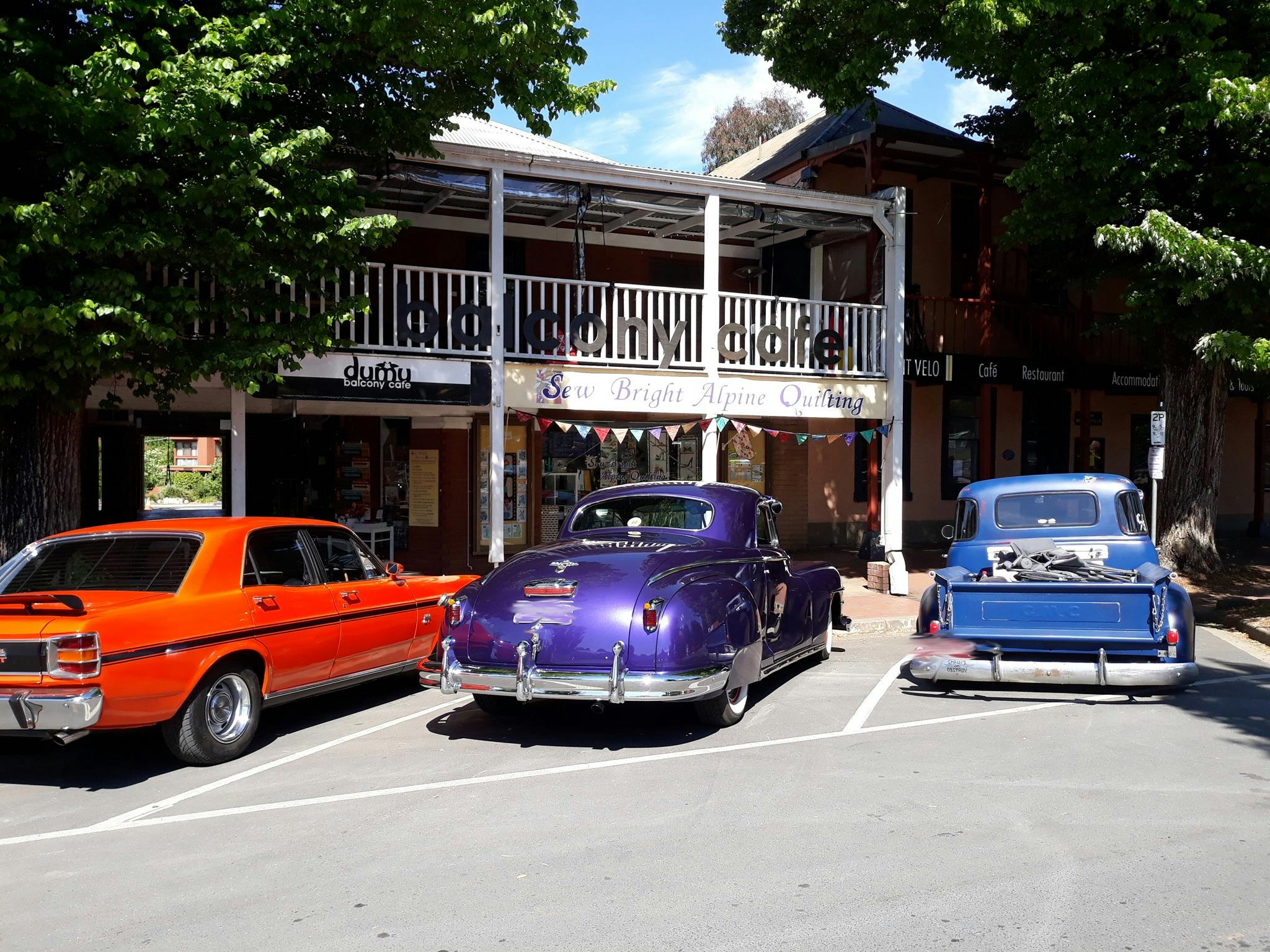 hot rods parked outside Sew Bright Alpine Quilting