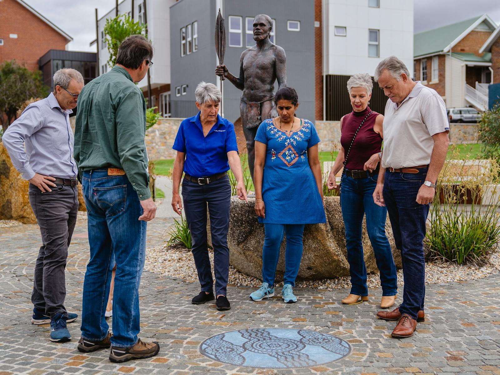small group looking to ground where guide is pointing