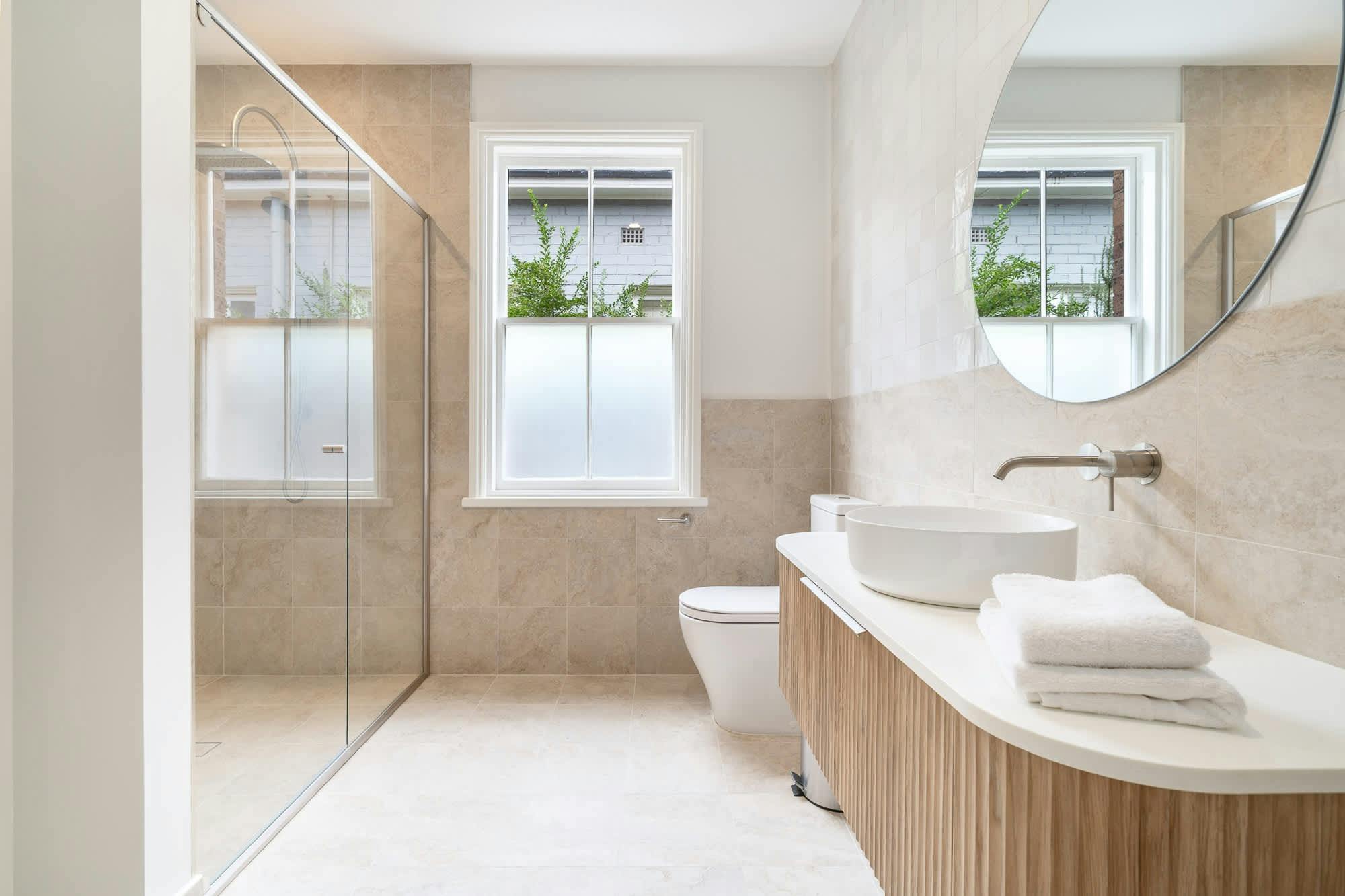Bathroom with shower, vanity and toilet with modern tiles, and fixtures