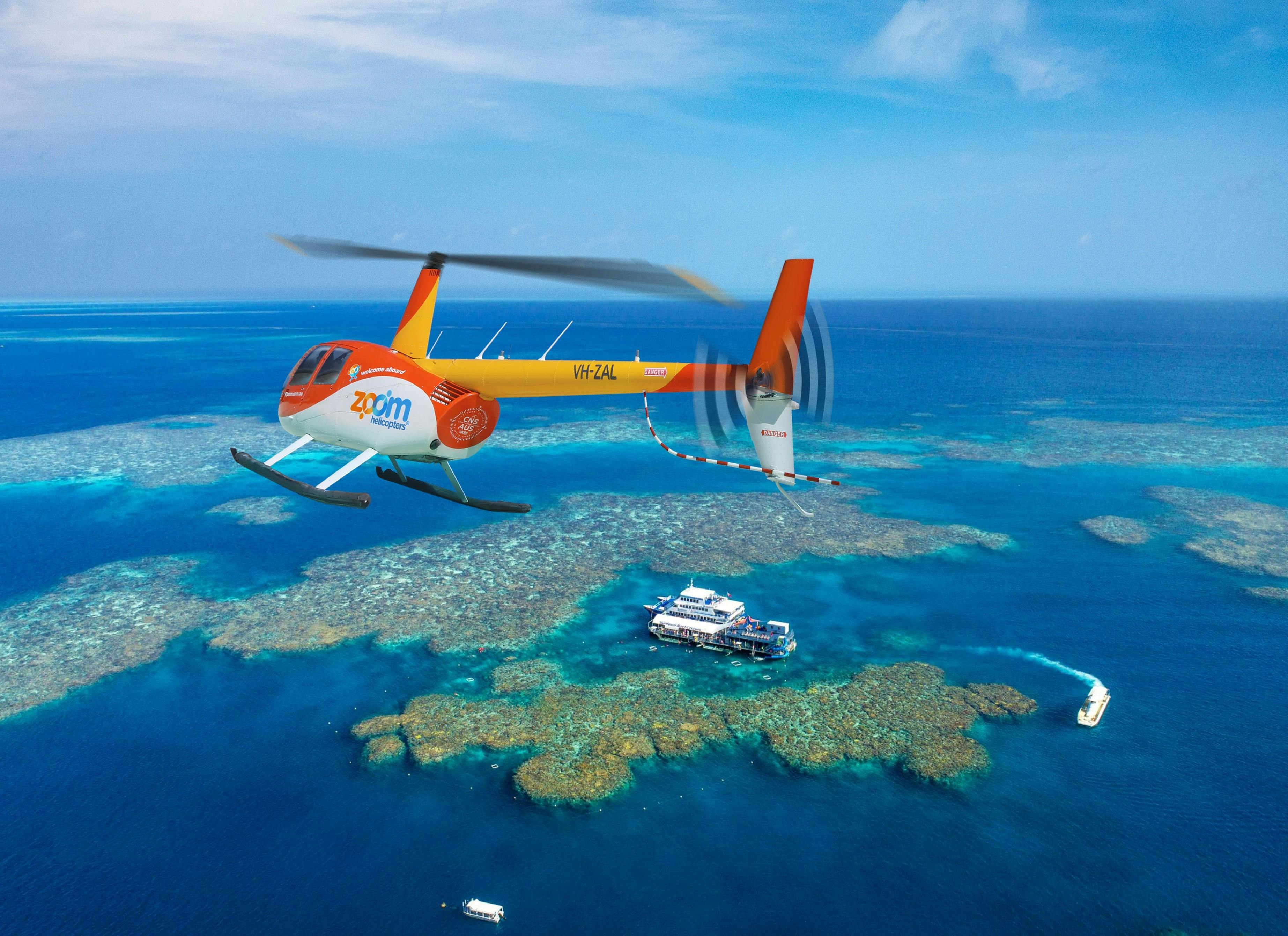 Zoom Helicopters flying over Moore Reef on the Great Barrier Reef.