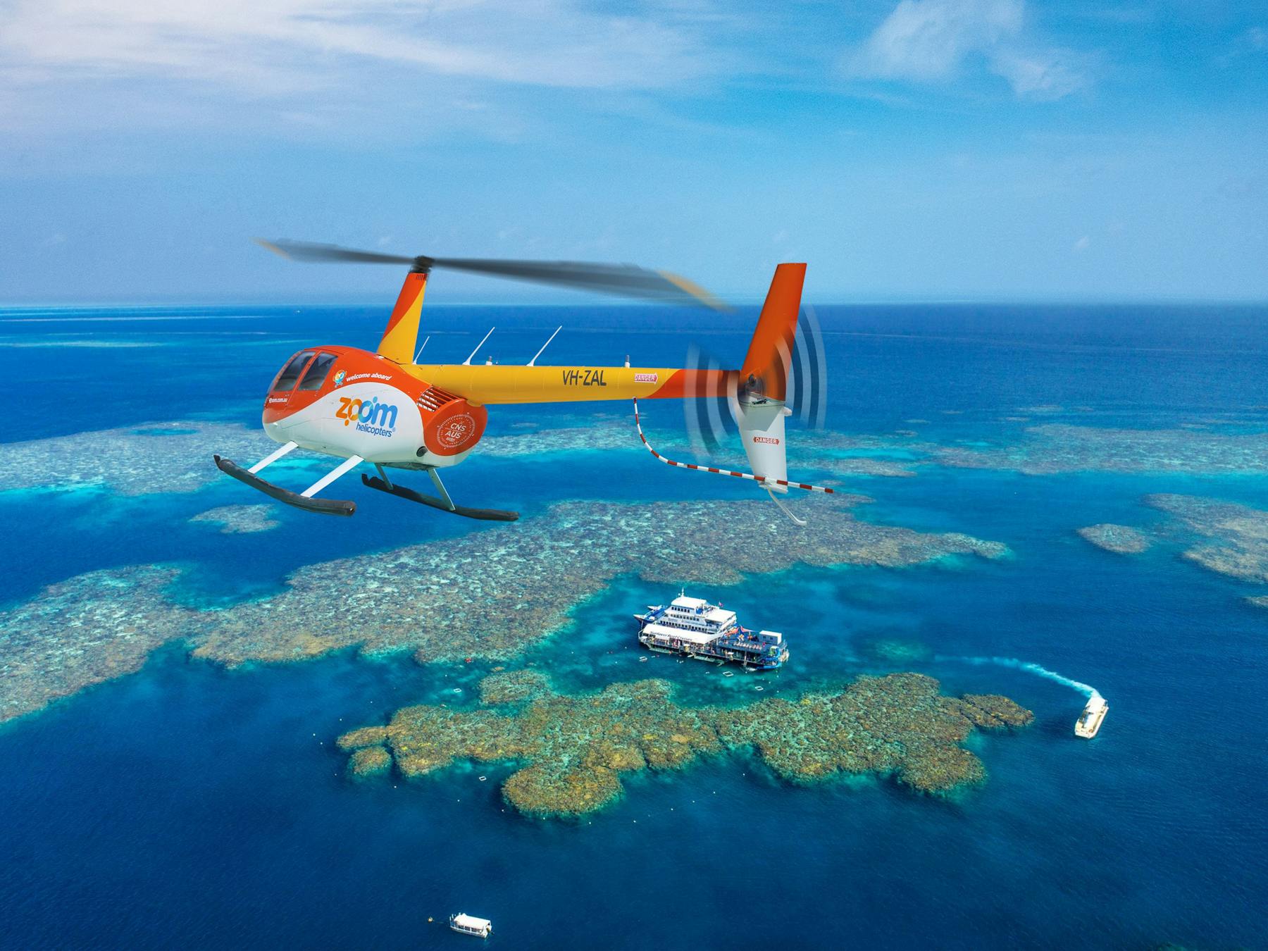 Zoom Helicopters flying over Moore Reef on the Great Barrier Reef.