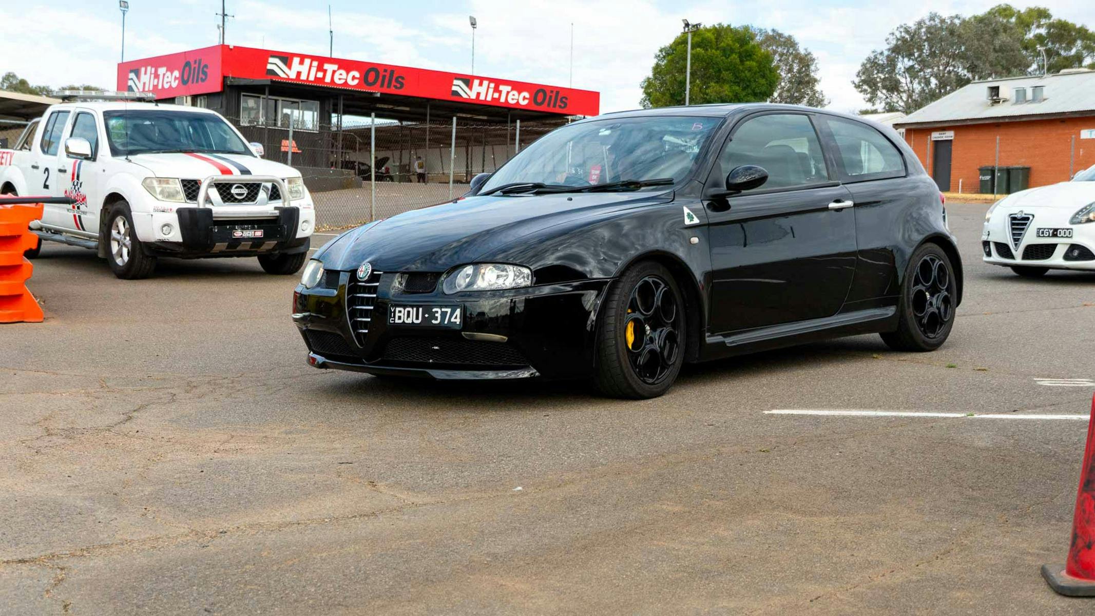 Black car rolling out from pre-grid