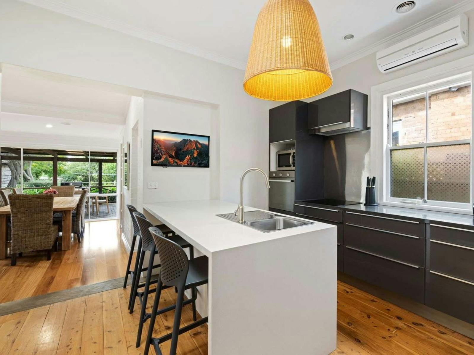 Kitchen with island bench, white and black cabinets