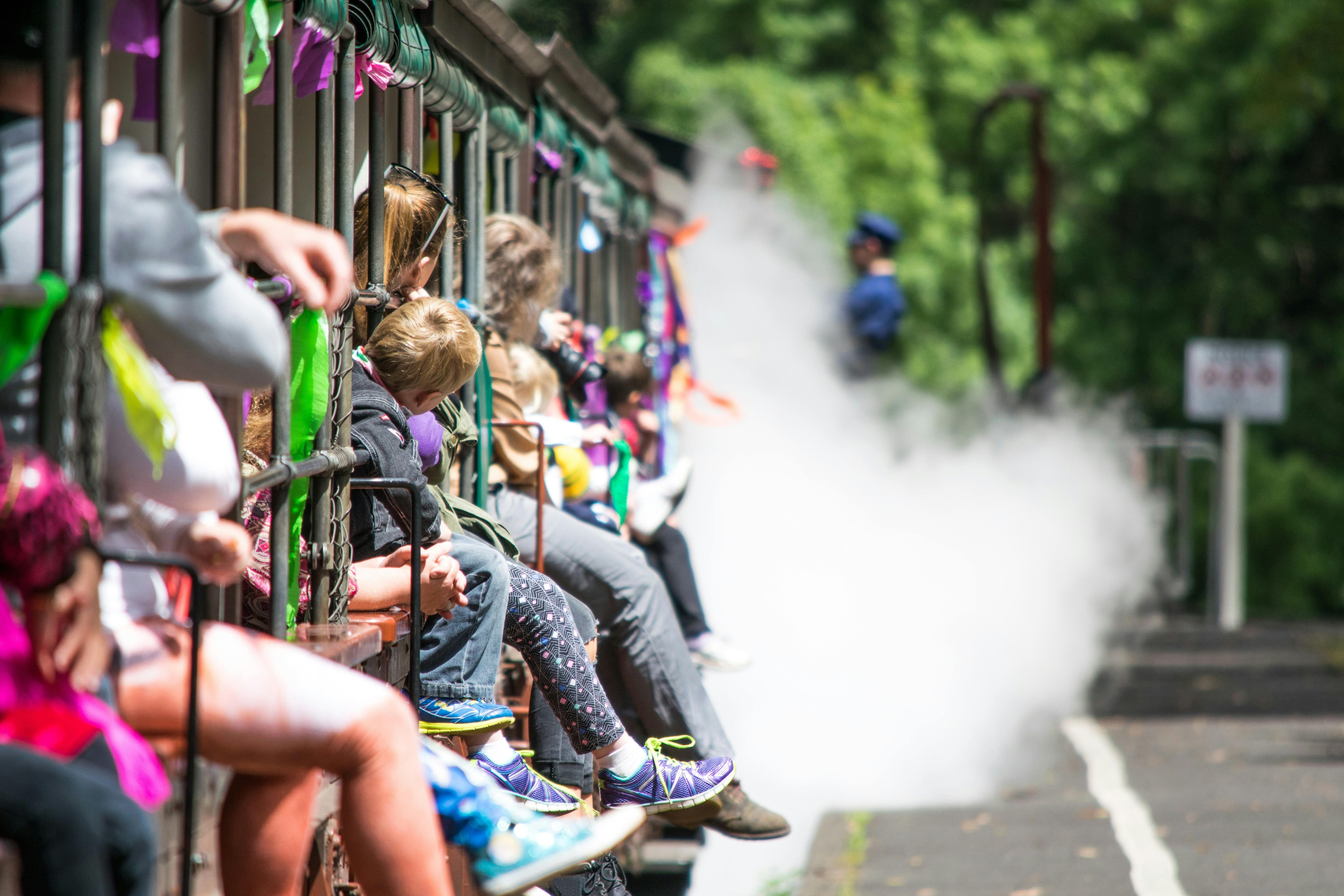 Children riding steam train - sitting on window ledge