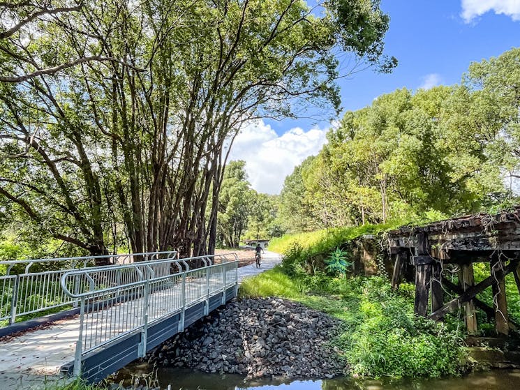 Shot of a cyclist in the distance past the Crabbes Creek bridges the Northern Rivers Rail Trail