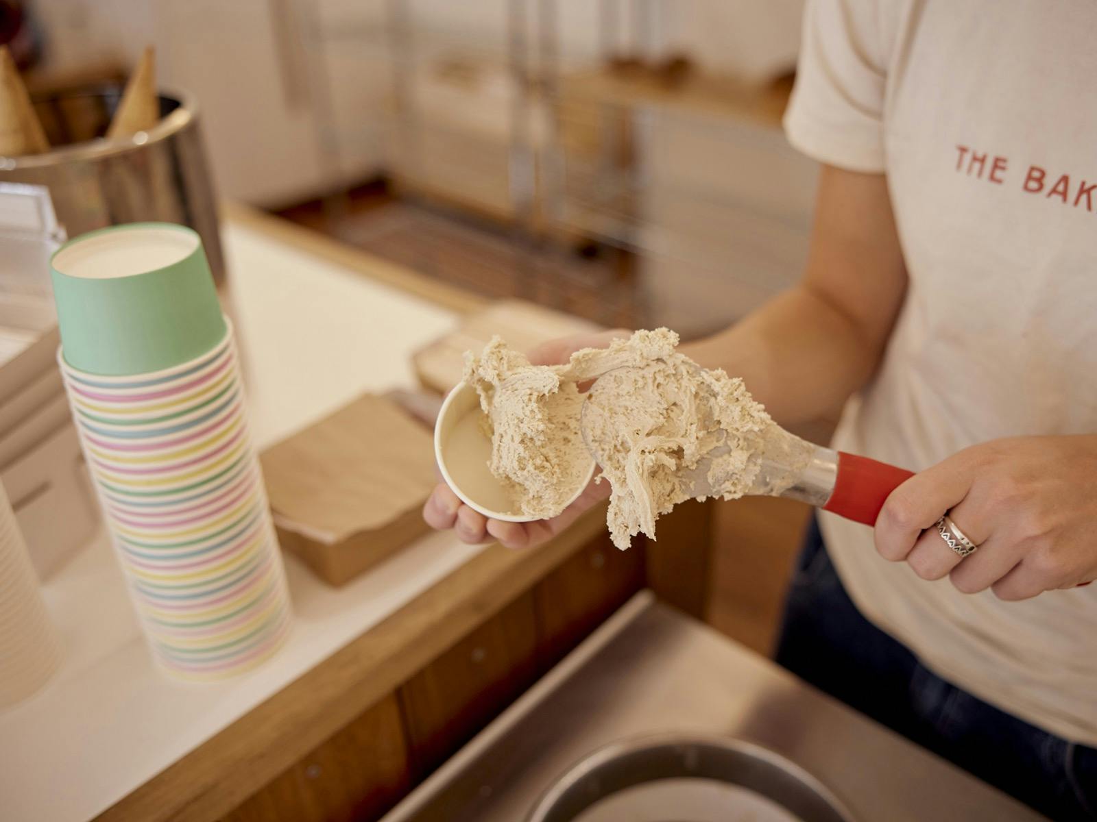 Staff making a single cup of gelato at the counter pozetti