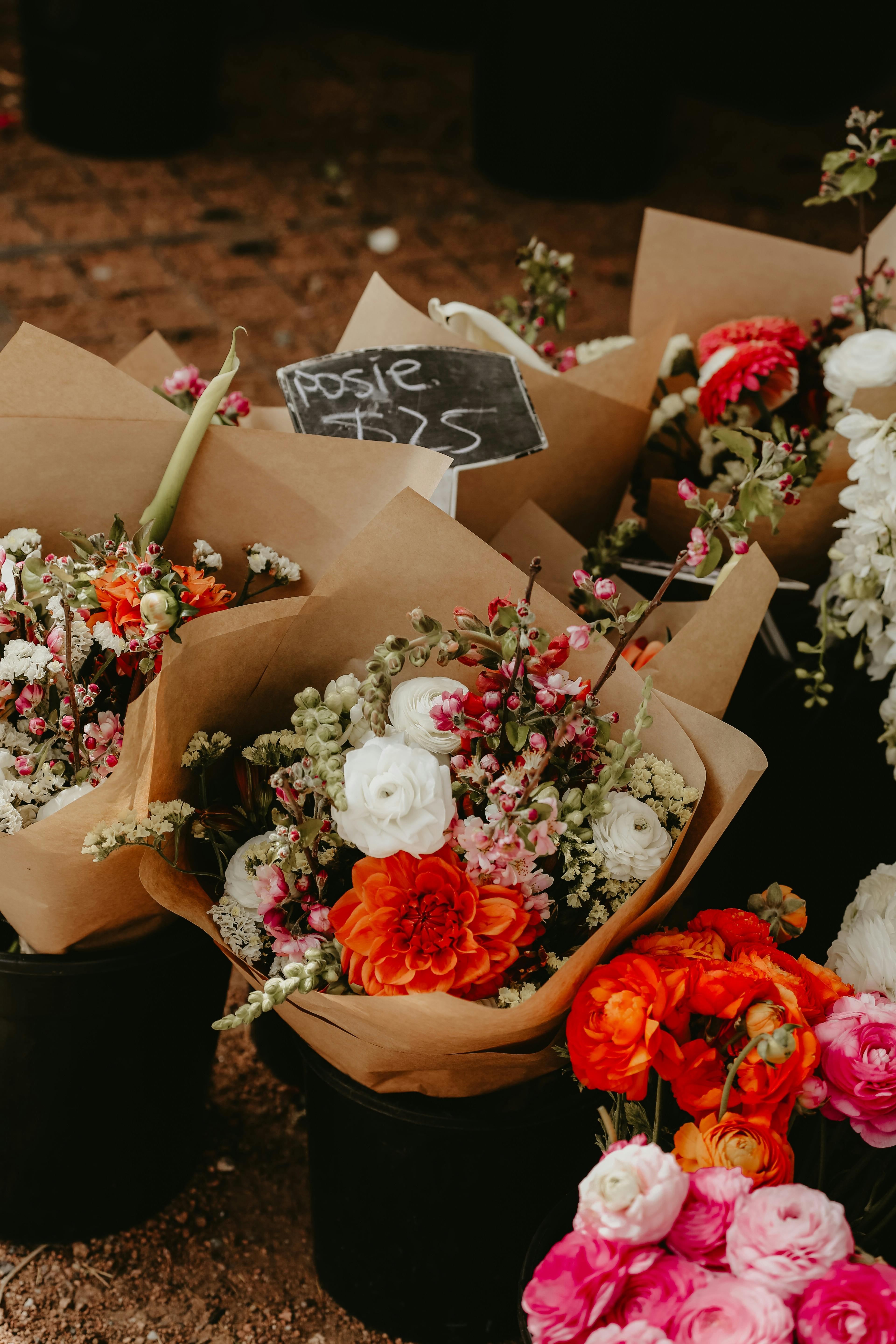 Mixed bunches of flowers wrapped up in brown paper
