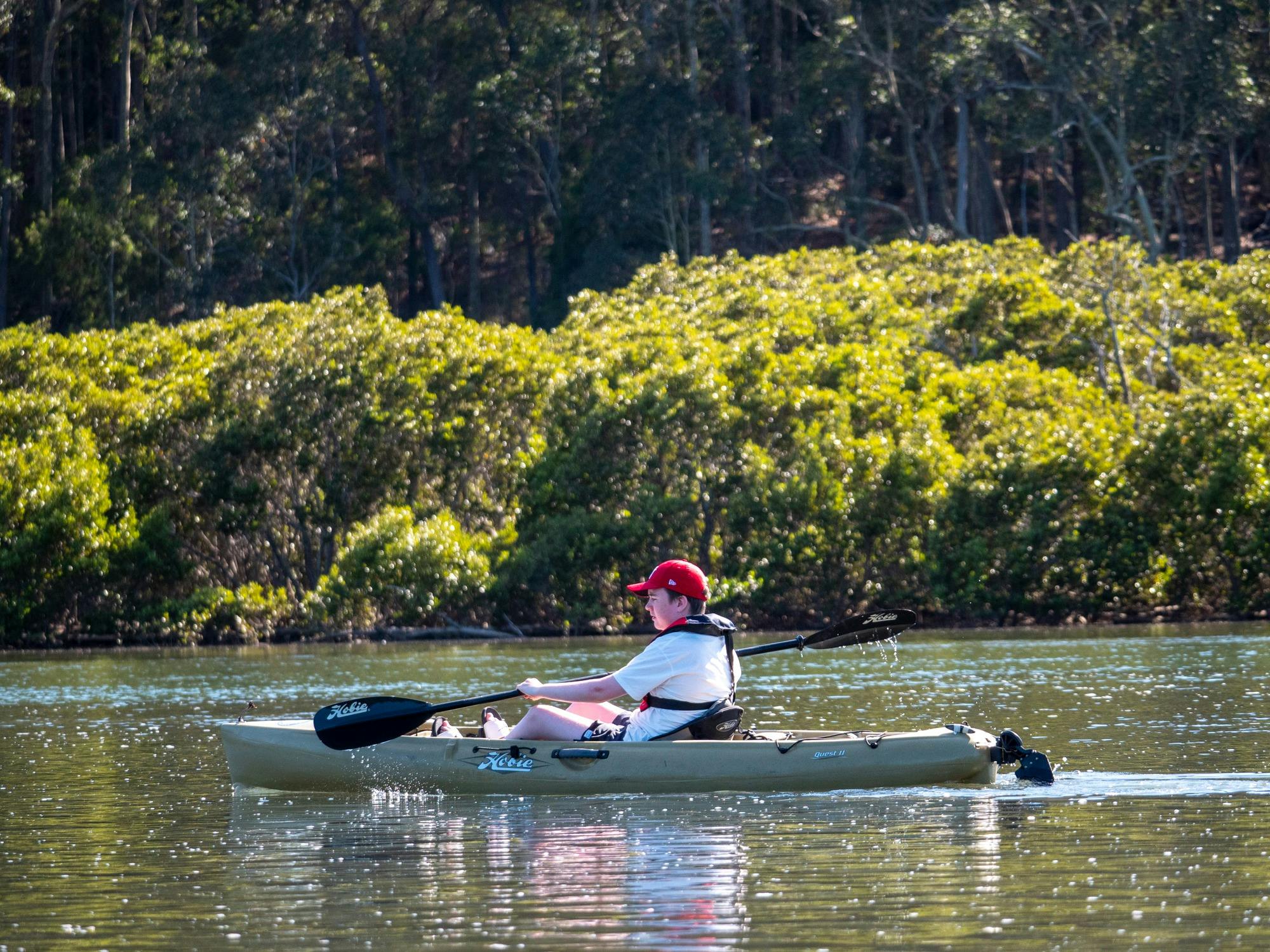 Kayaker paddeling the Bermagui River