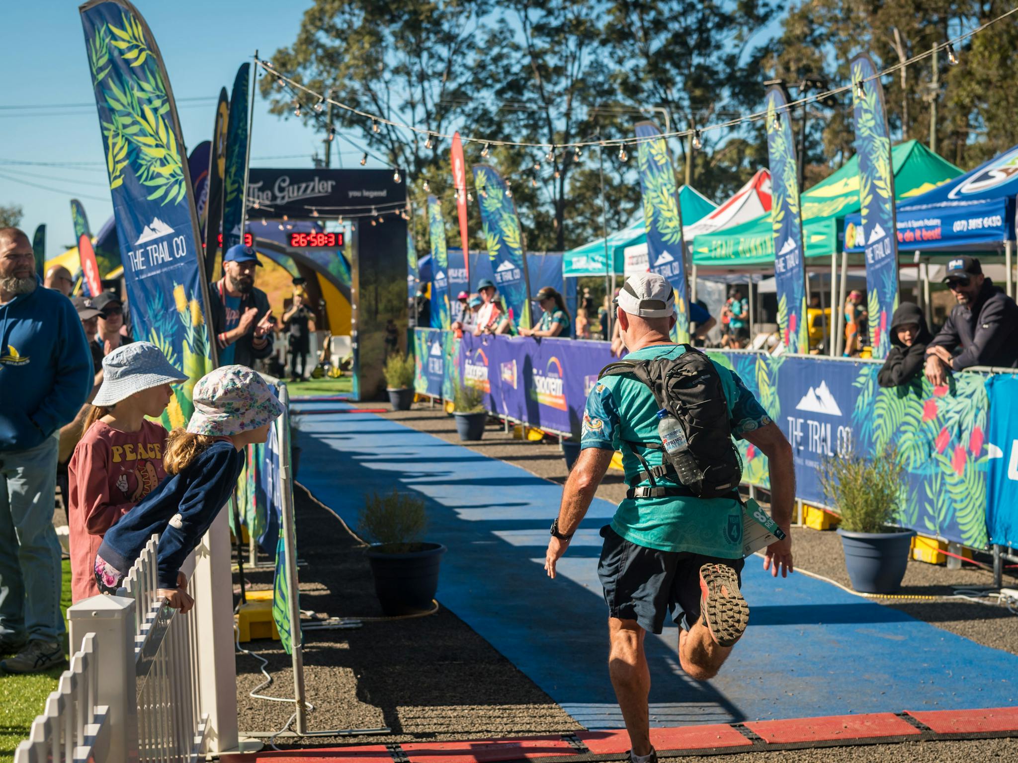 The Guzzler Ultra Finish chute lined with flags, spectators and tents The Guzzler Ultra Finish chute lined with flags, spectators and tents