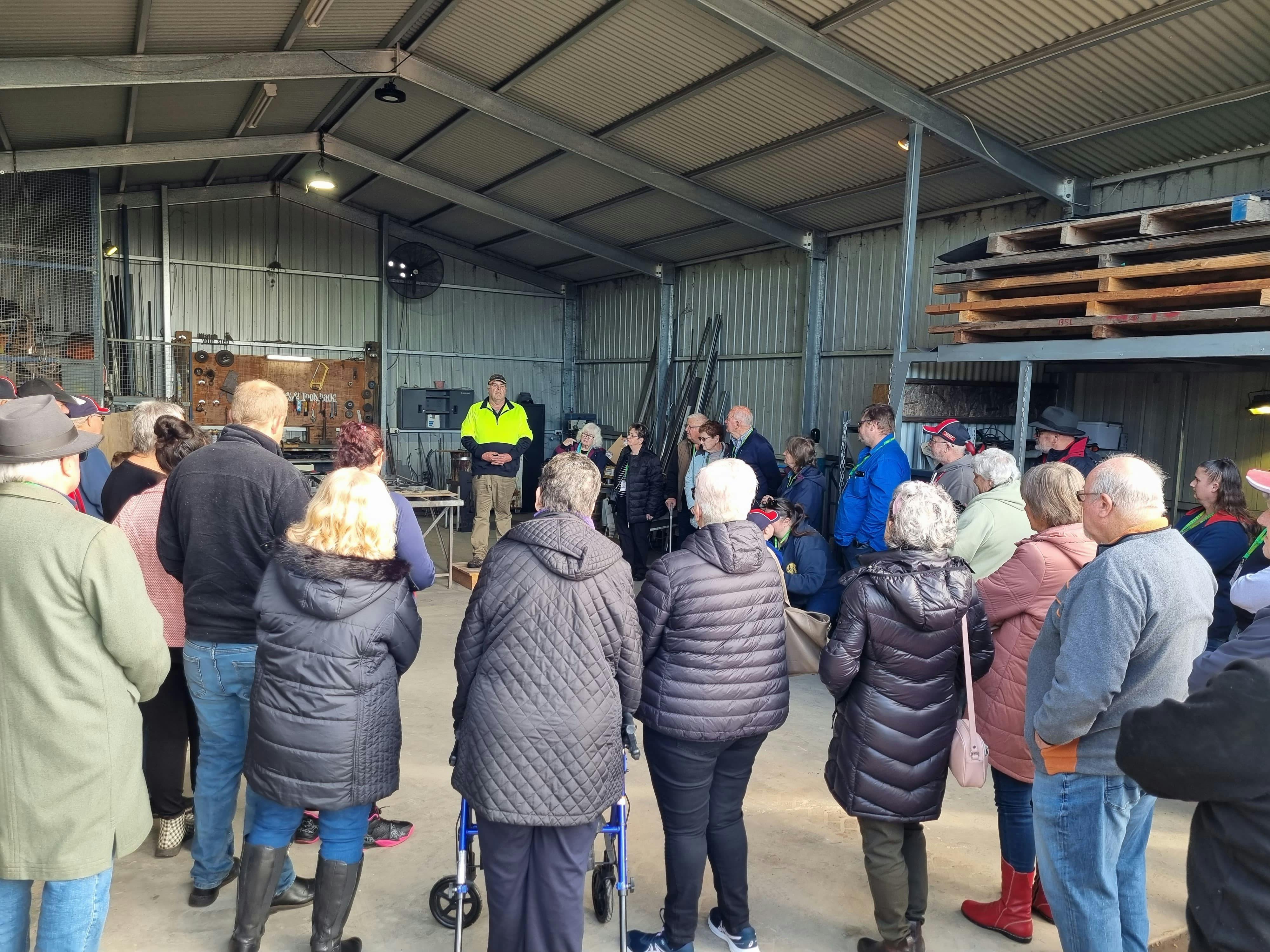 Owner John Wicker giving a talk to group of people for a tour