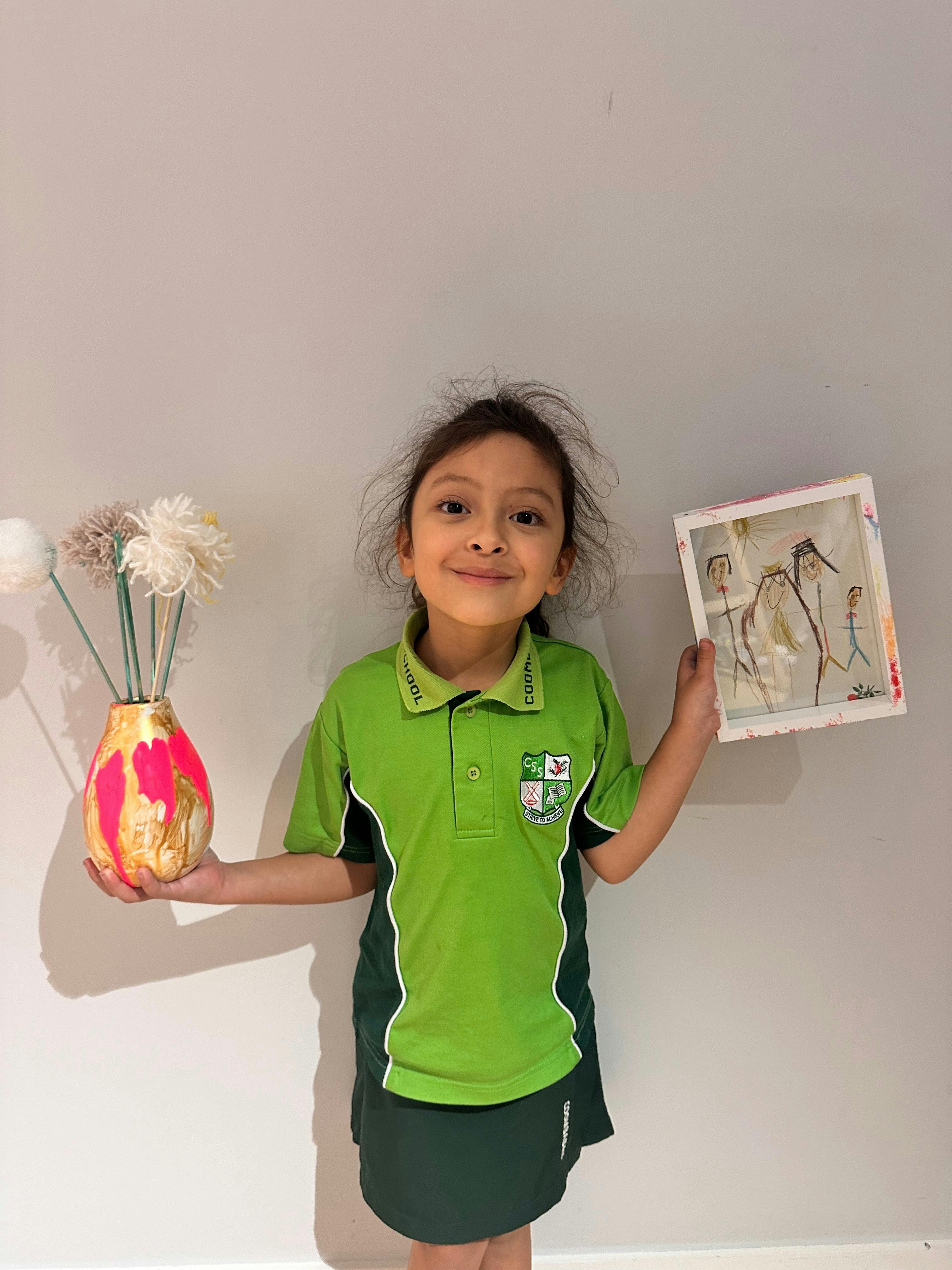 Child showing off her artwork at The Point Studio