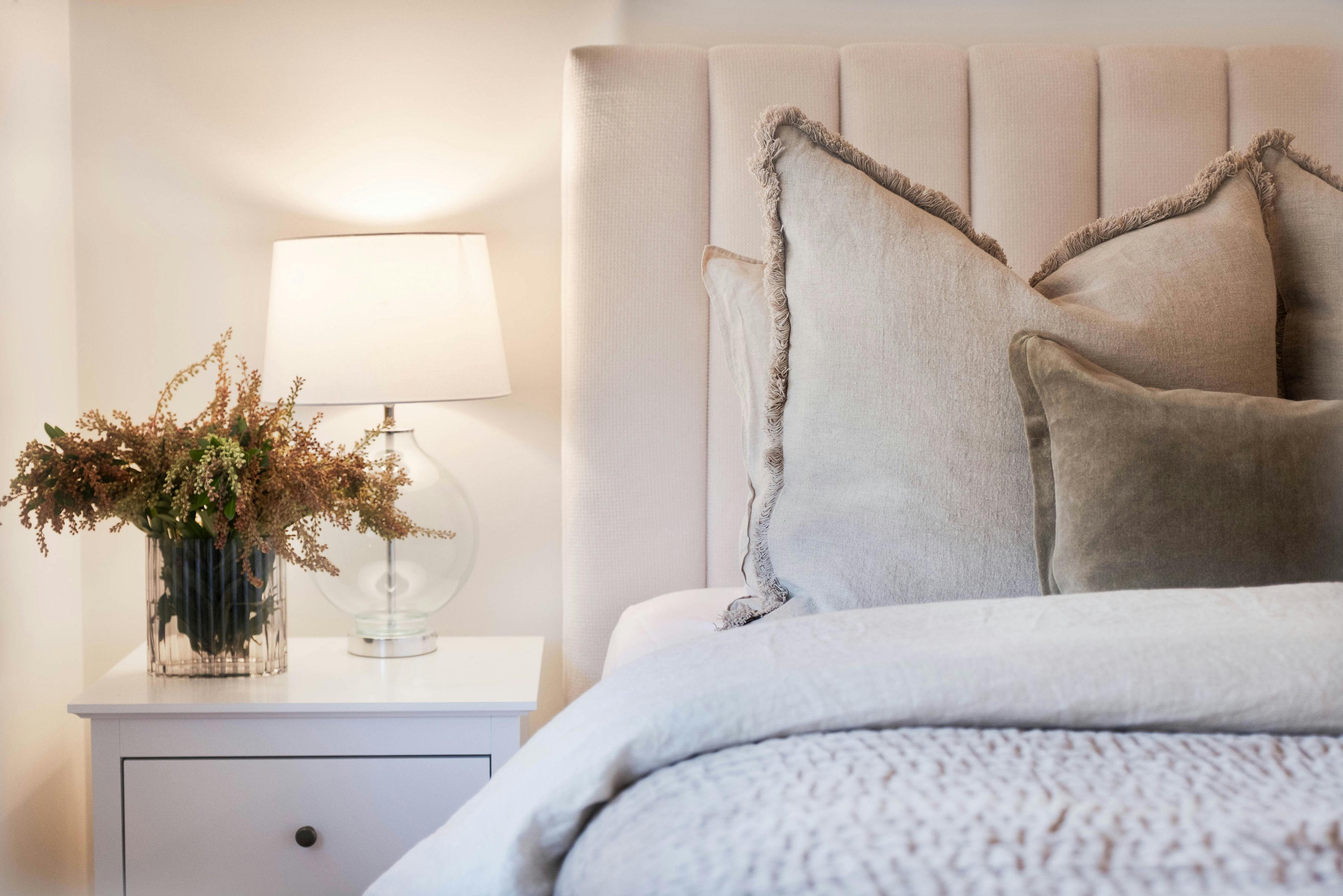 Corner Cottage Bright Bedroom Master with a bedside table and lamp