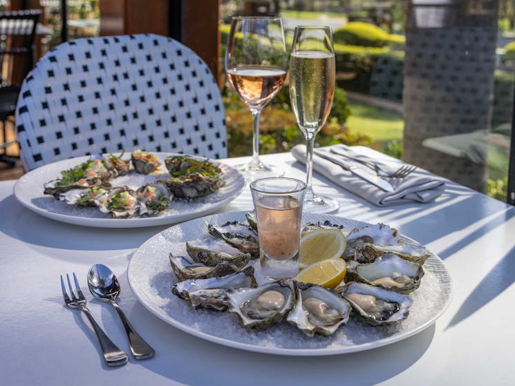 A sunny spot for lunch with sparkling wine and natural oysters