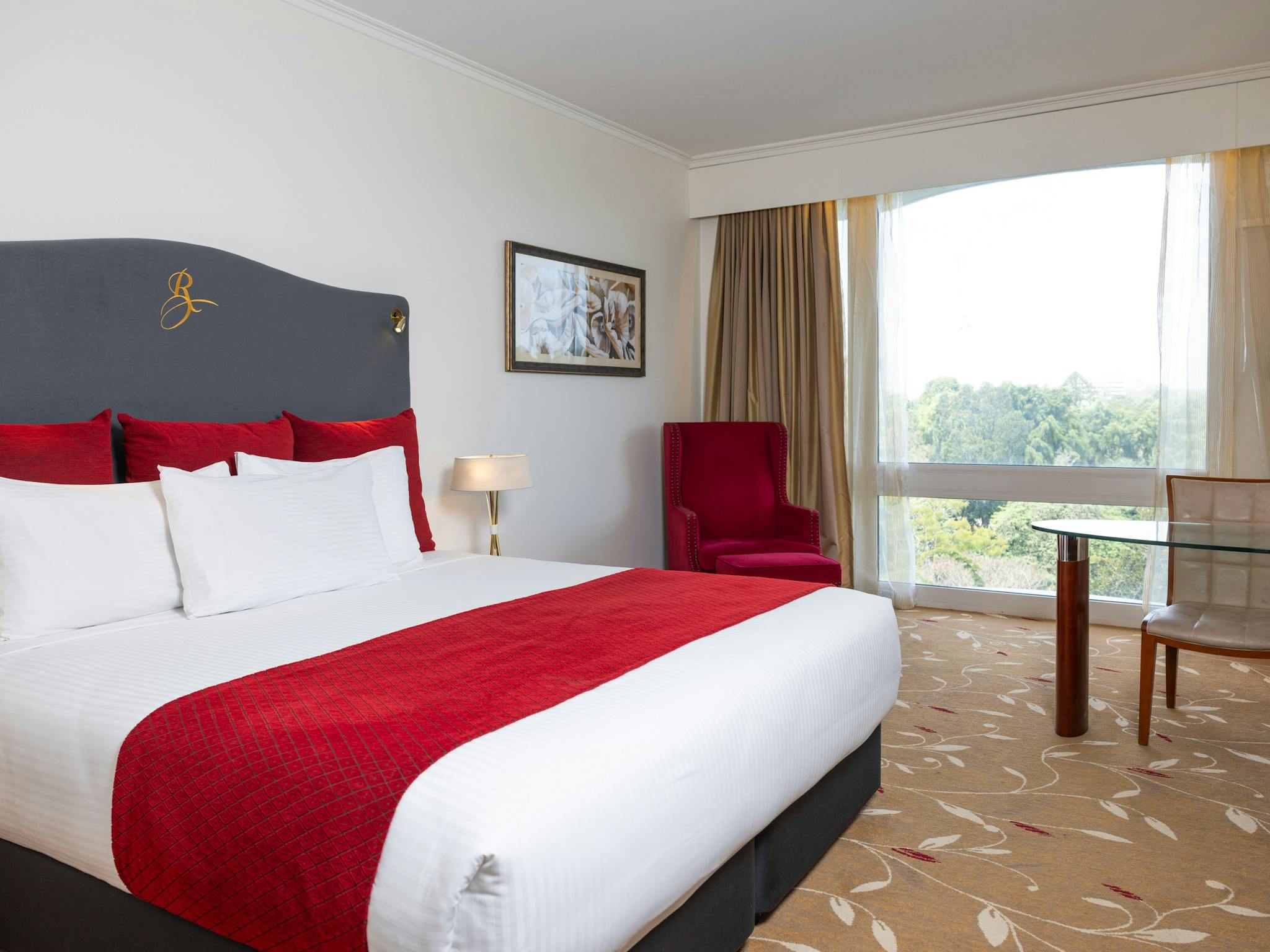 King bed and red chair in Premium room at Royal on the Park Hotel Brisbane, view of Botanic Gardens King bed and red chair in Premium room at Royal on the Park Hotel Brisbane, view of Botanic Gardens