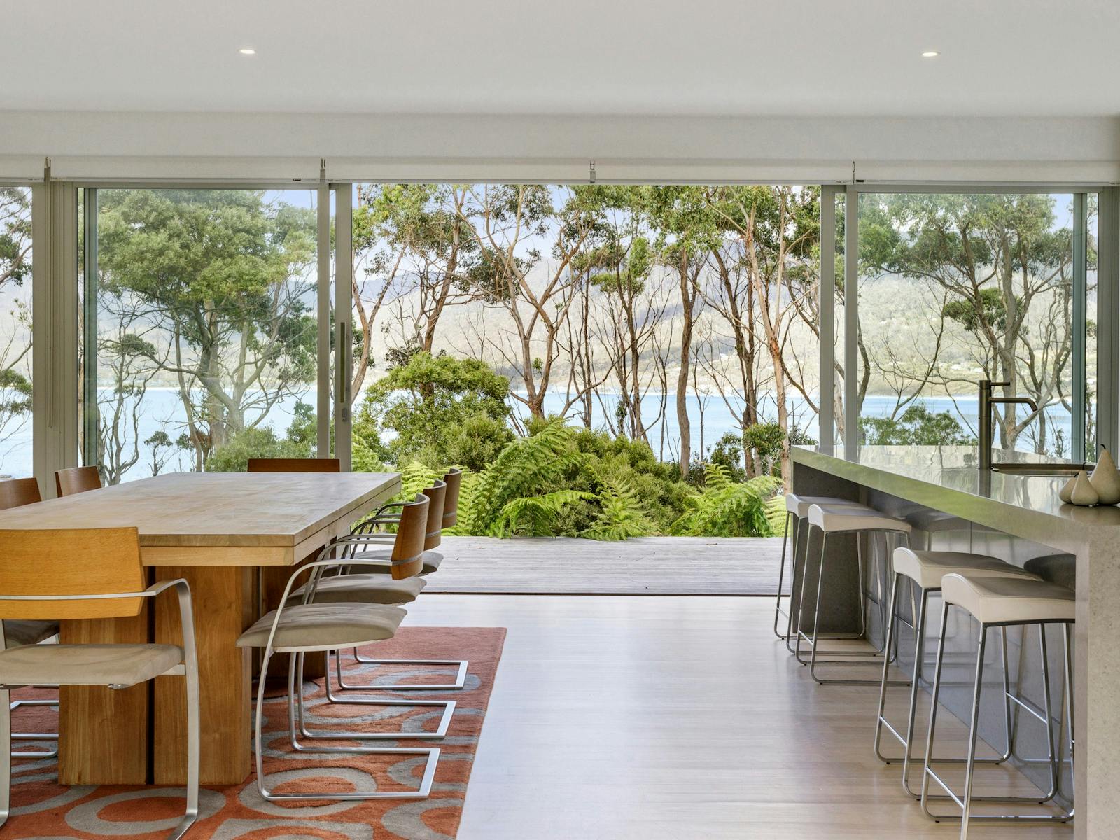 The dining area flows out onto the front deck with views over the bay.