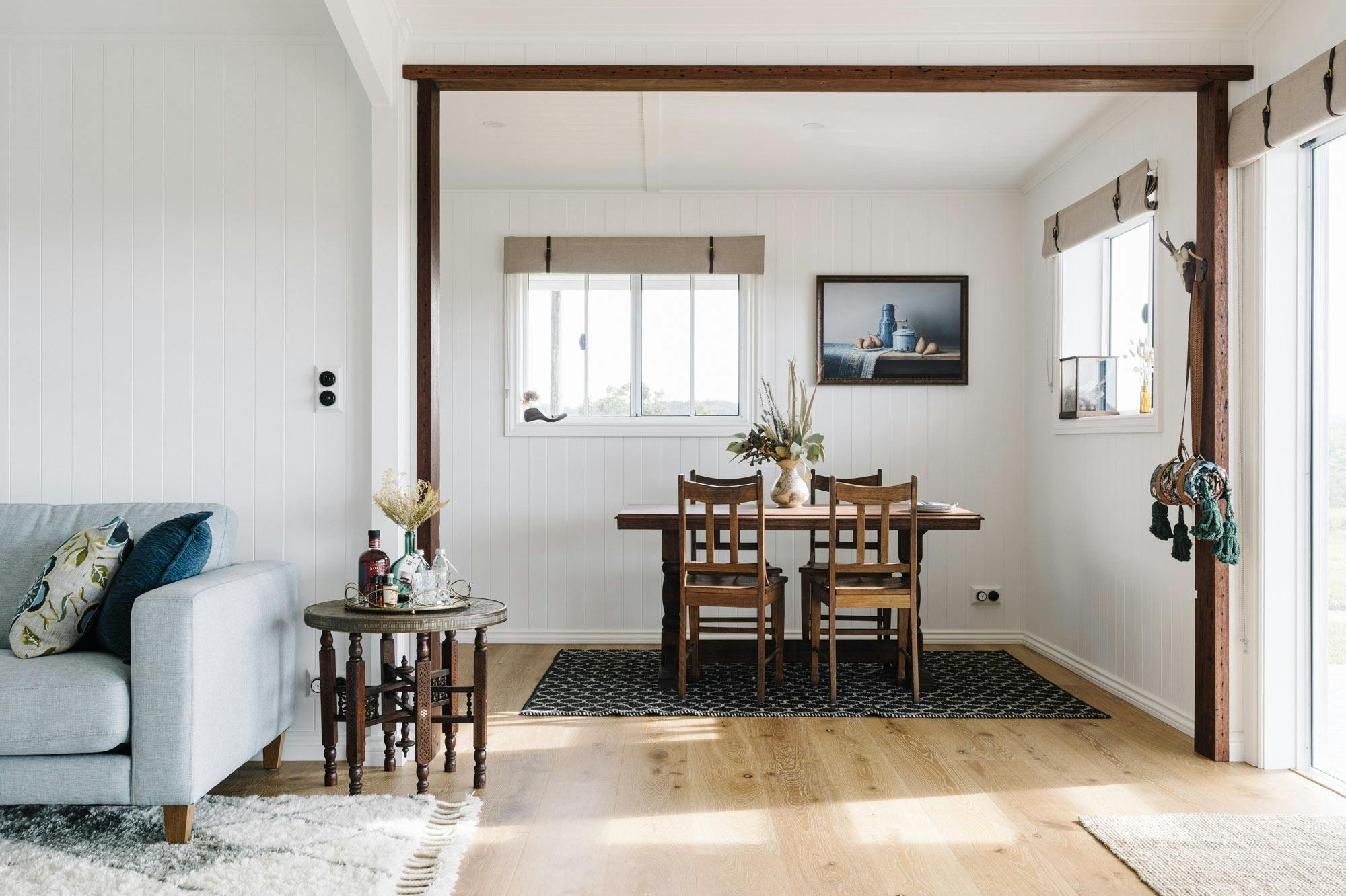 Vintage dining table and drinks table with reclaimed timber beams around doorways