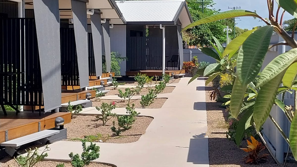 Modern individual motel style cabins with private ensuite, air-conditioning and outdoor deck.