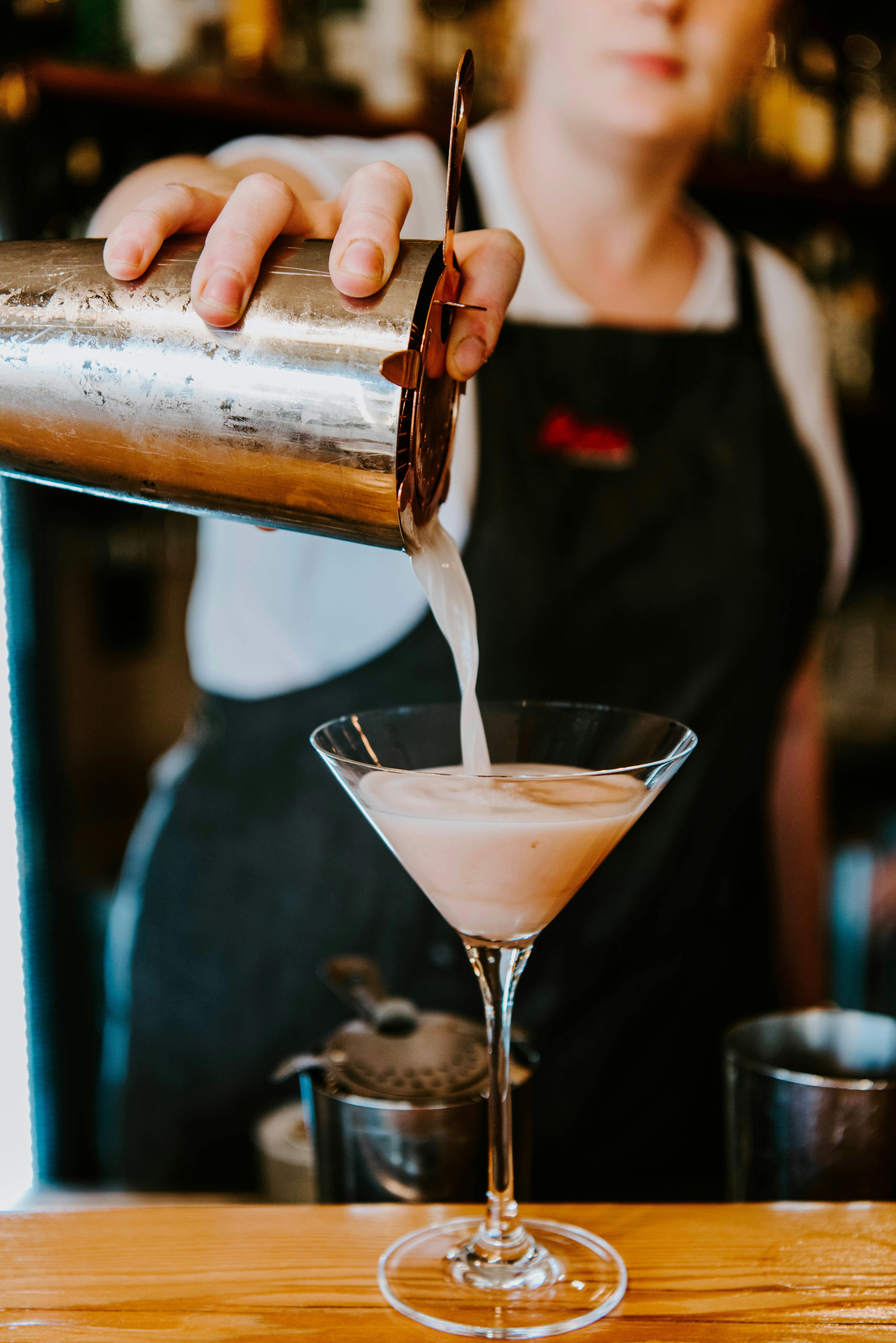 French Martini being poured from cocktail shaker into martini glass