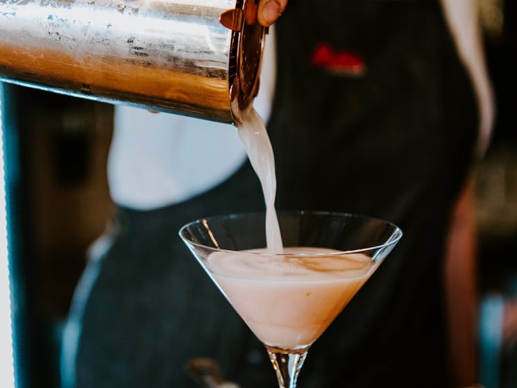 French Martini being poured from cocktail shaker into martini glass