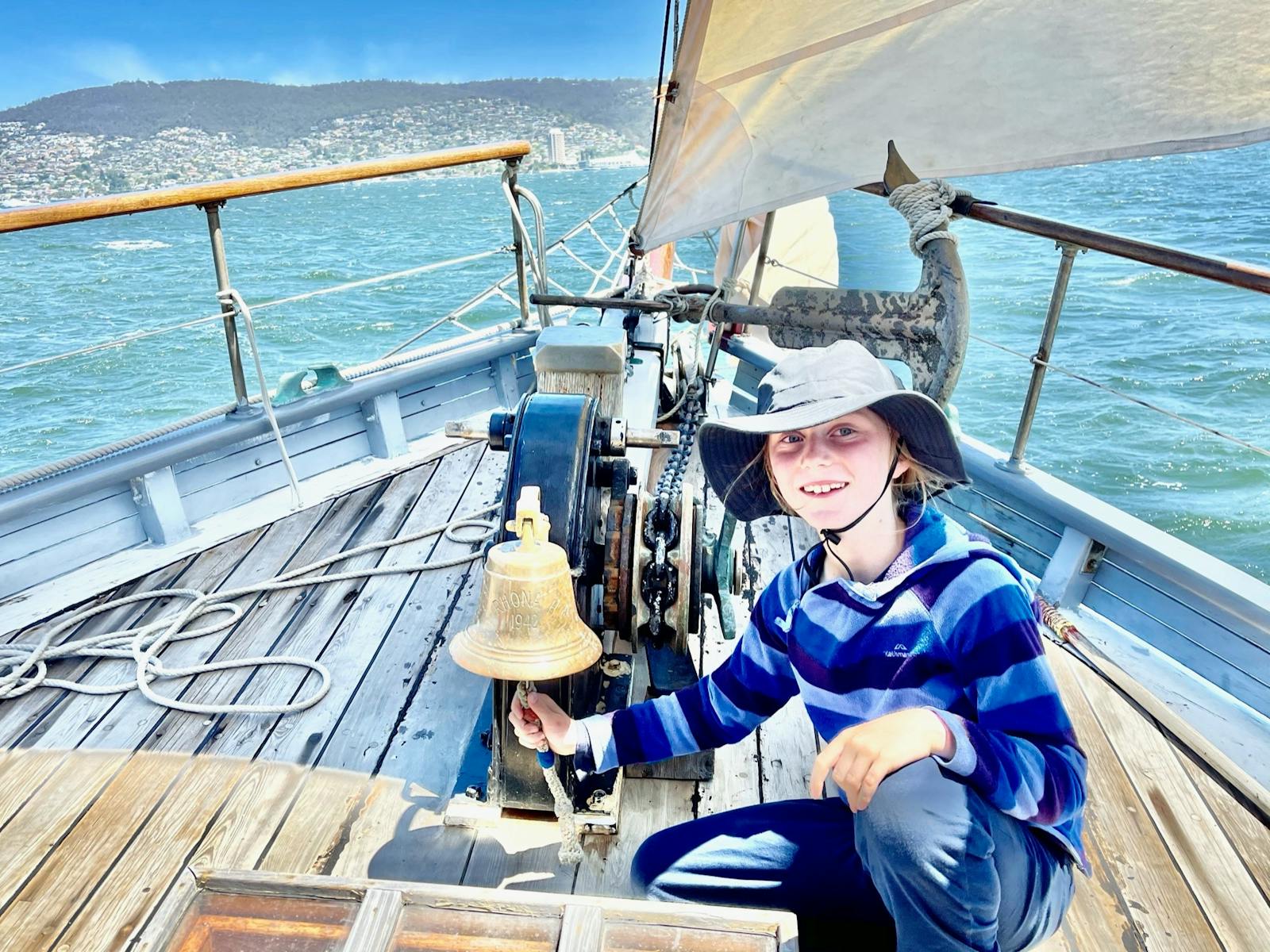 One of the guests onboard SV Rhona H ringing the bell