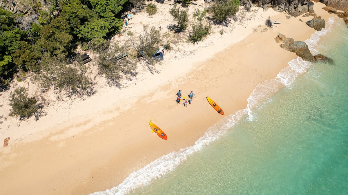 Aerial view of Steens beach and waters edge showing people and kayaks on beach