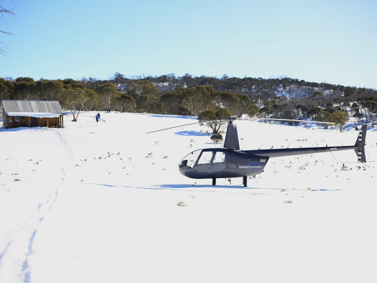 Robinson R44 landed on snow at private hut for Wilderness Picnic