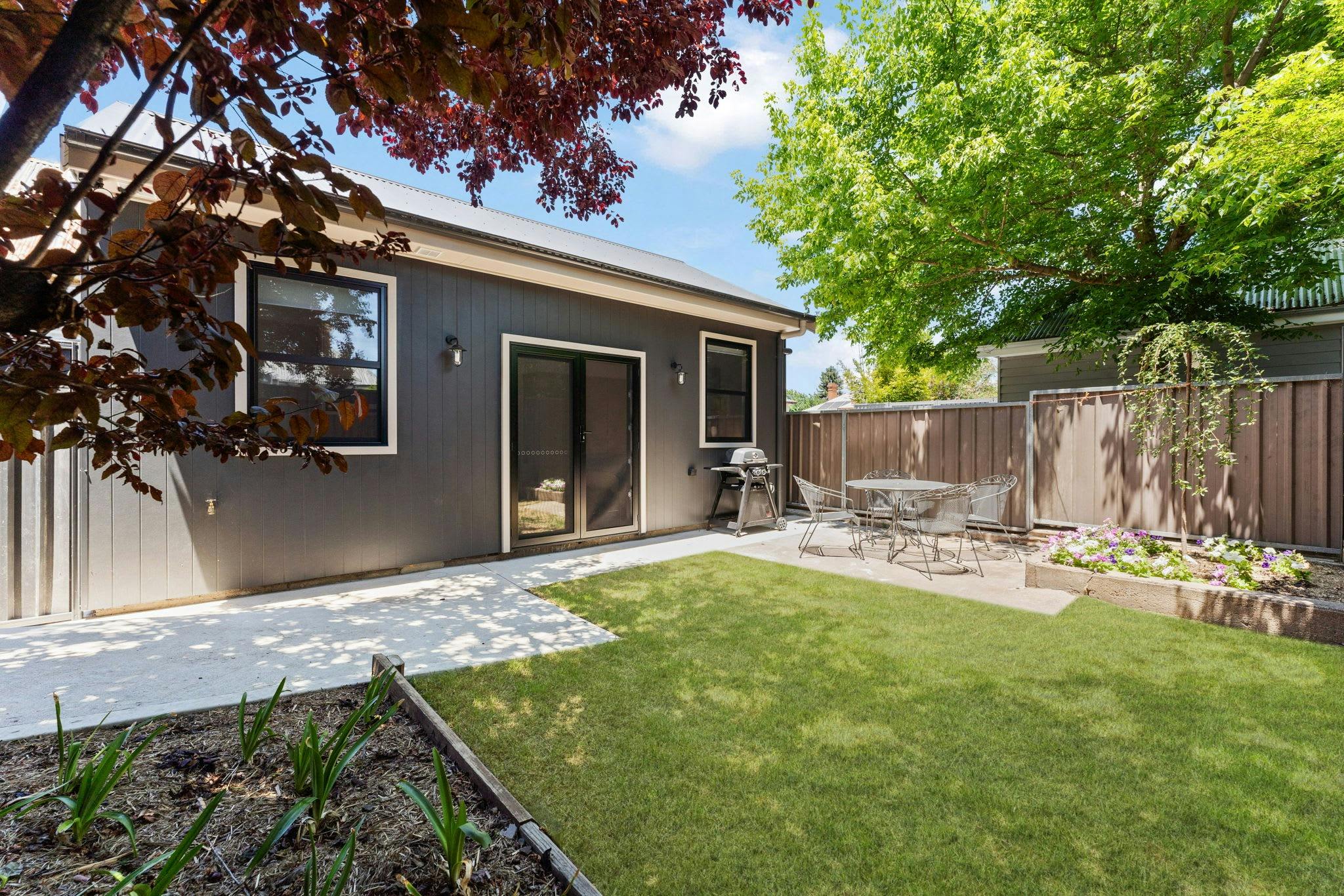 Outdoor grass, bbq and dining area