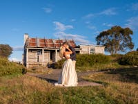 Just married couple sealed their marriage with a kiss with Craig's Hut as a backdrop.