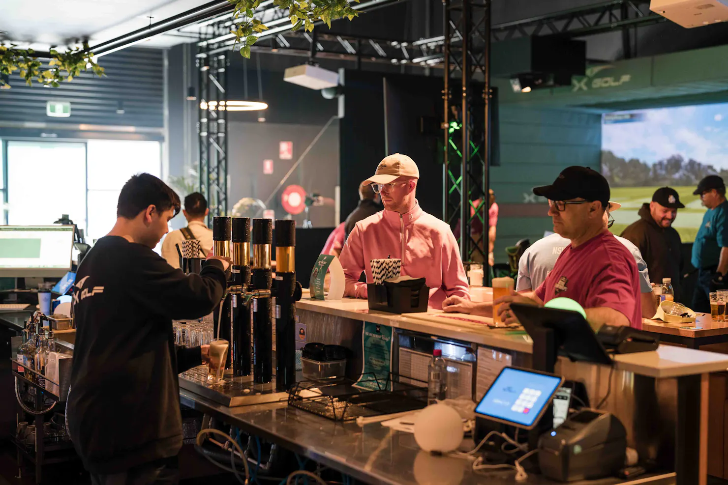 People Ordering Beer at X-Golf Venue