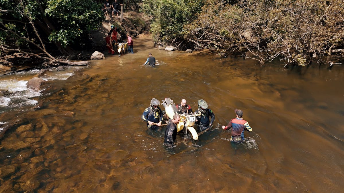 Riders carrying bikes through the Pascoe River Riders carrying bikes through the Pascoe River
