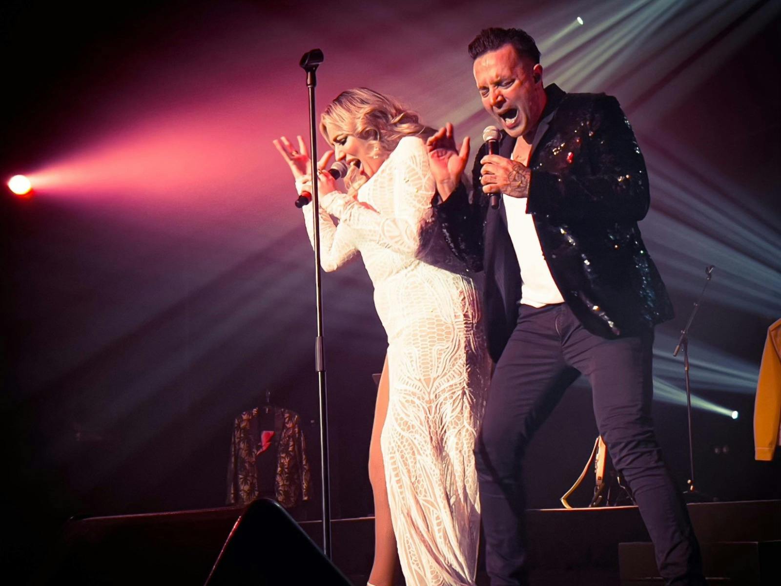 Jason Singh and Sarah C singing together on stage