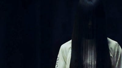 Faceless figure with long black hair and black background