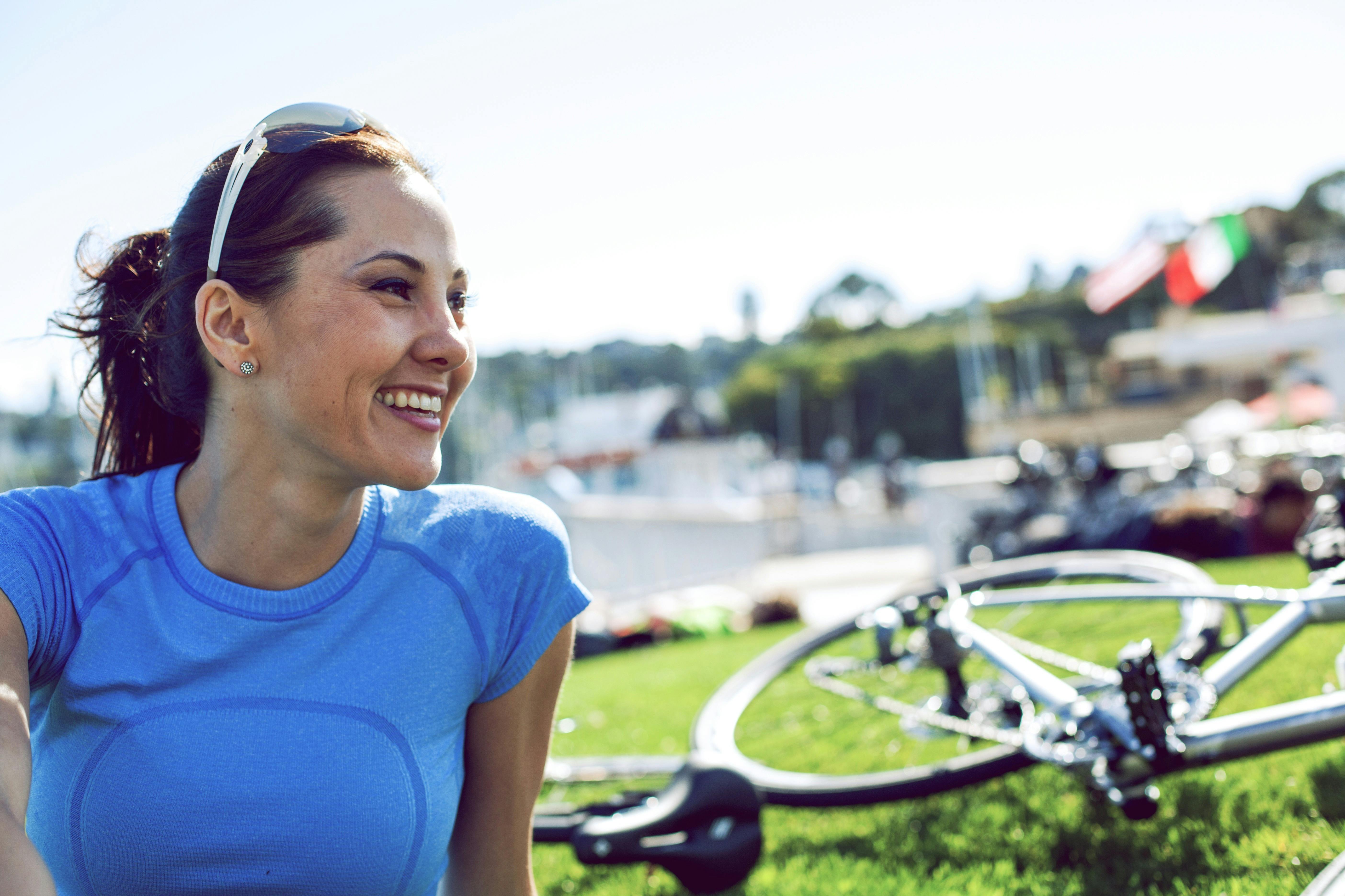 woman relaing on ground by  bicycle