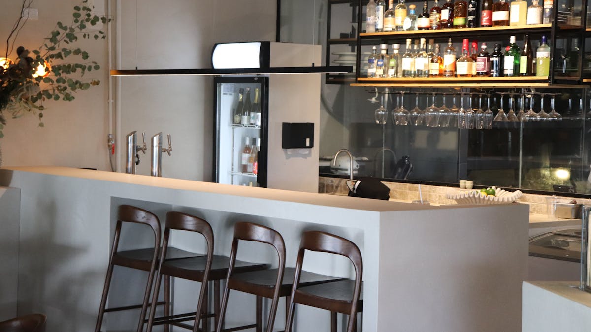 Modern bar with high brown wooden chairs