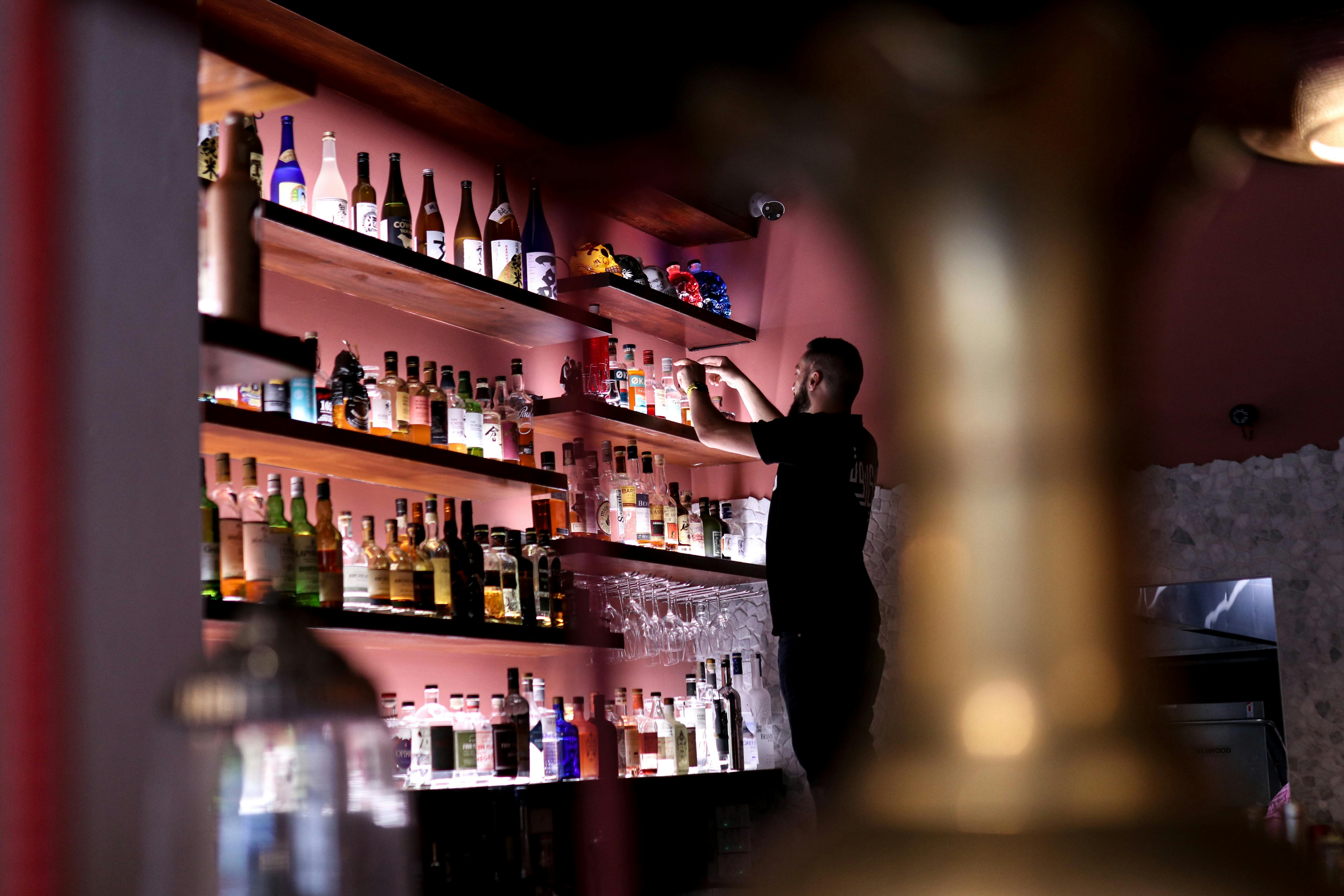 Bartender stocking shelves