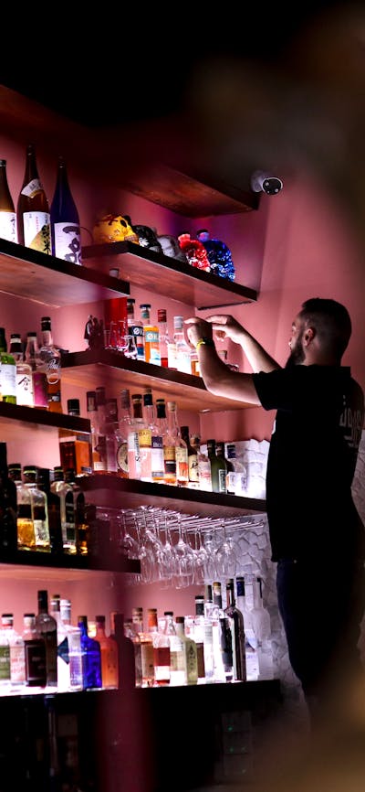 Bartender stocking shelves