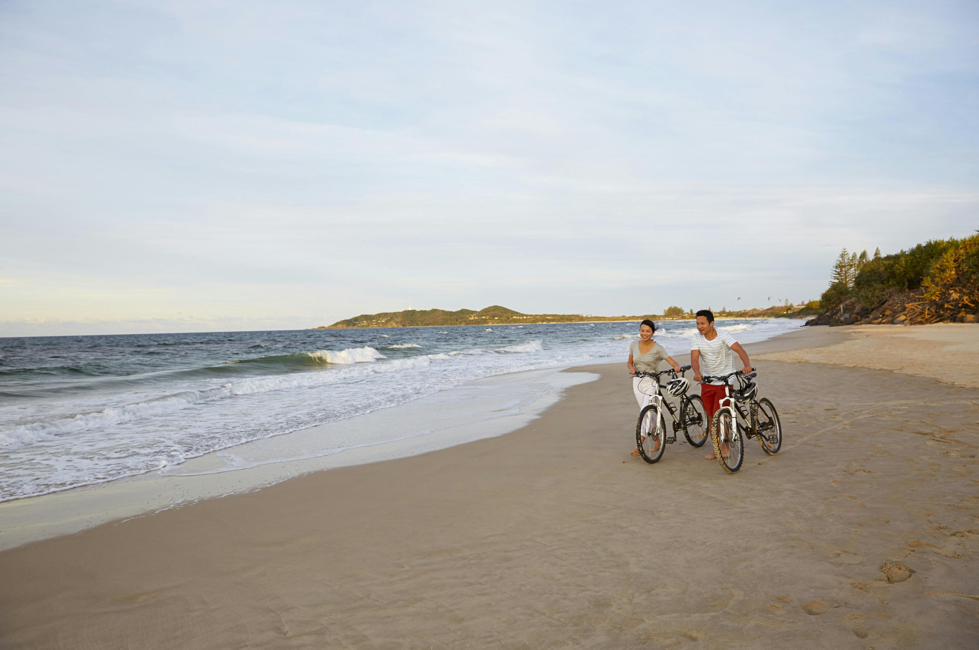 A couple enjoying Belongil Beach, Byron Bay