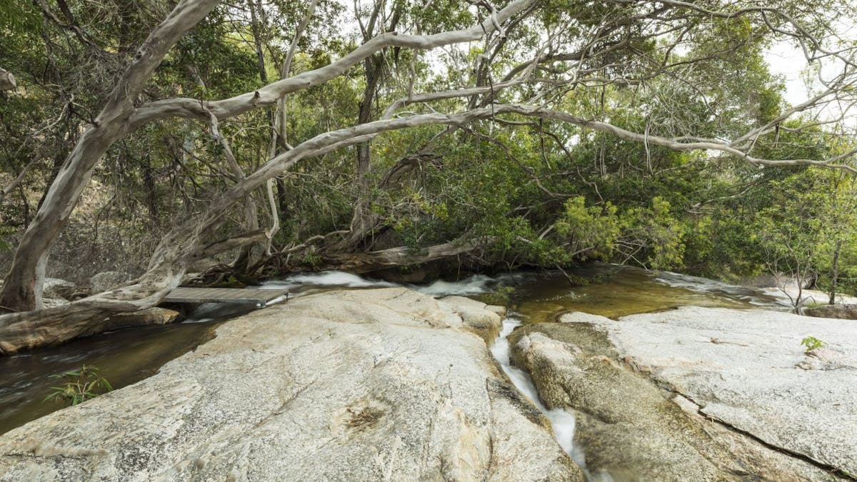 Granite boulders with a creek flowing over them.