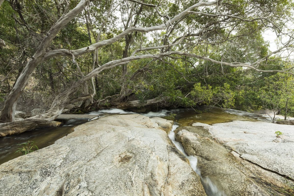 Granite boulders with a creek flowing over them.