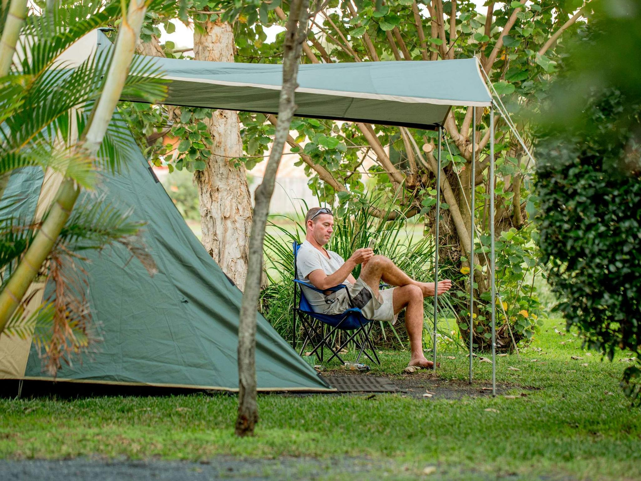 Image of a lone camper sitting outside next to his tent