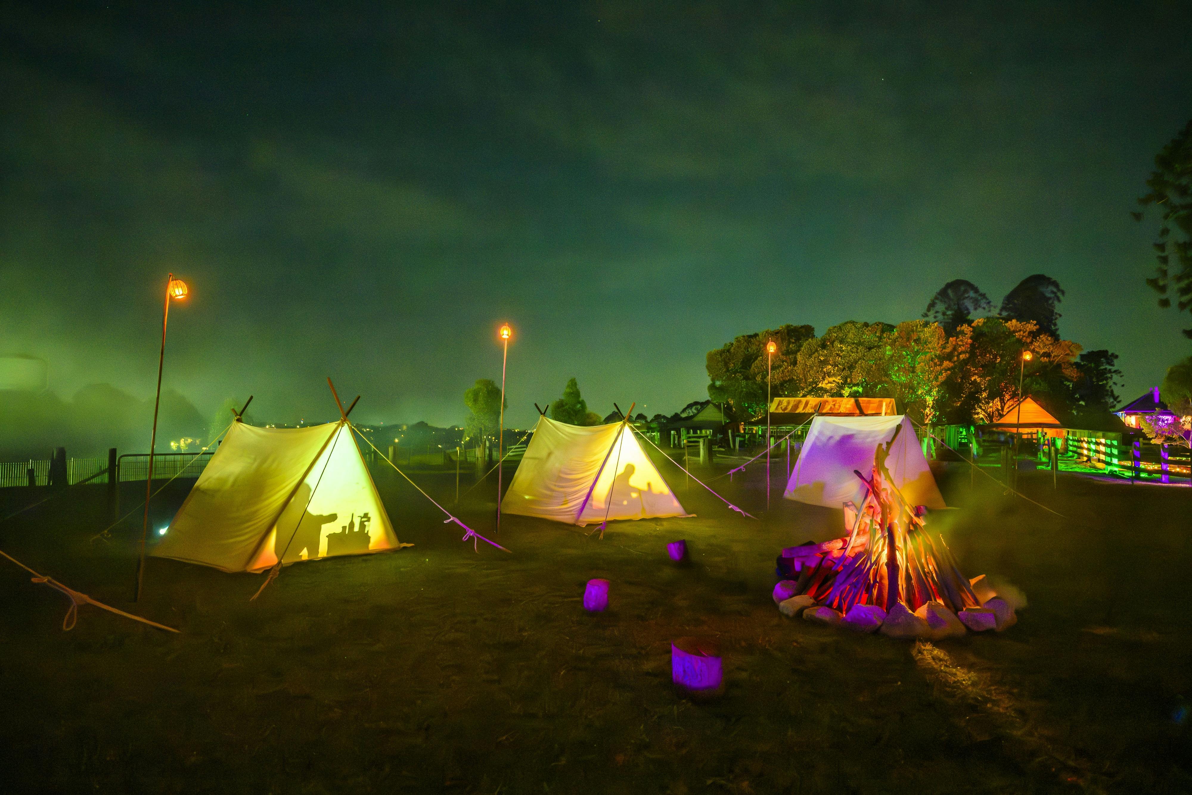 Settlers camping with the city in the background