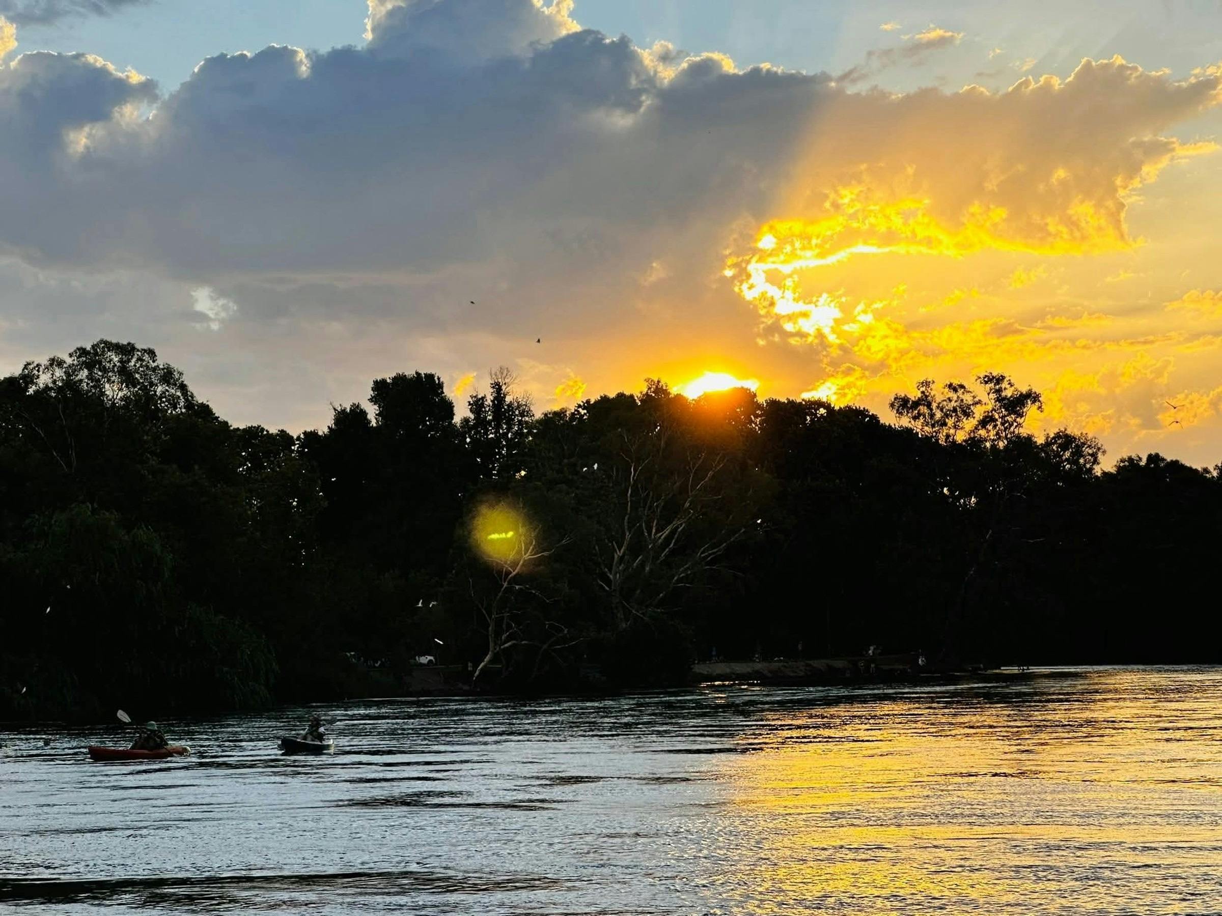 Golden sunset with paddlers on the Murray River