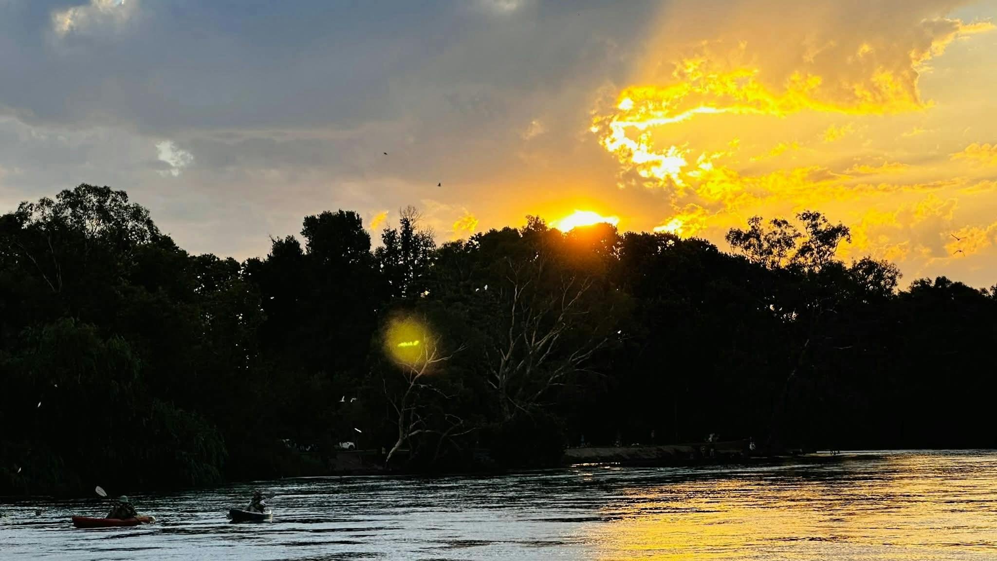 Golden sunset with paddlers on the Murray River