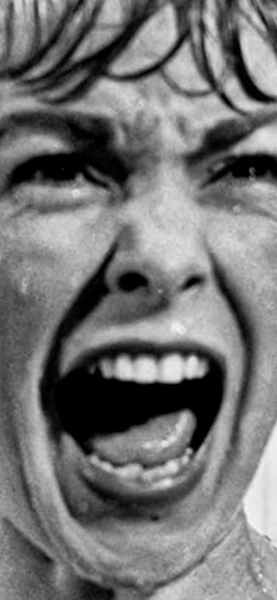 A woman in the shower screaming at the camera
