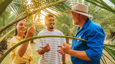 Date farmer entertaining tourists Date farmer entertaining tourists