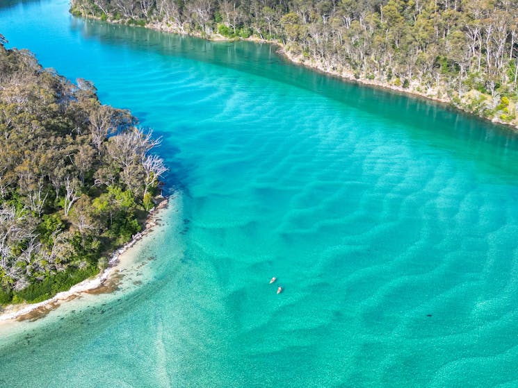 Kayakers on the blue water of Pambula