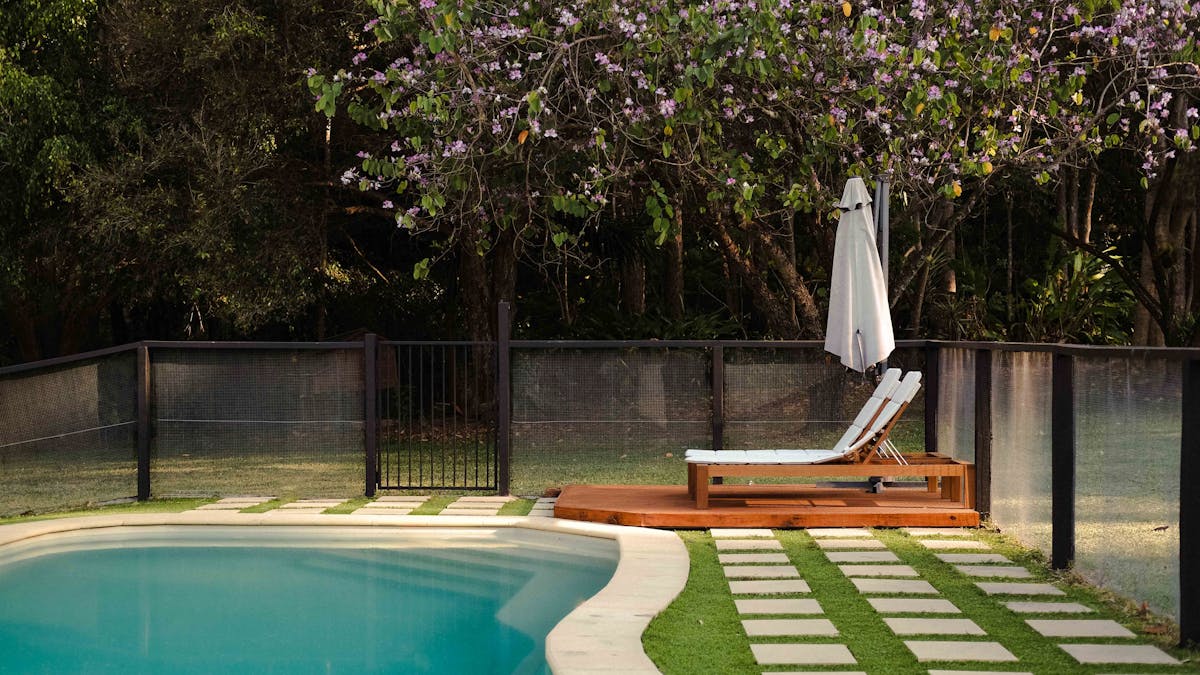 Swimming pool are with two deck chairs
