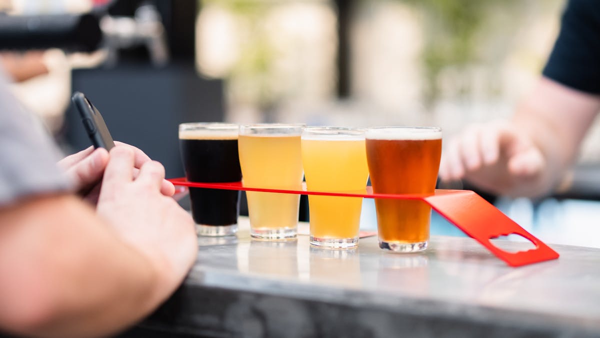 Selection of 4 tap beers on a tasting paddle at Slipstream Brewing.