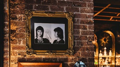 Brick wall with portraits in dining area