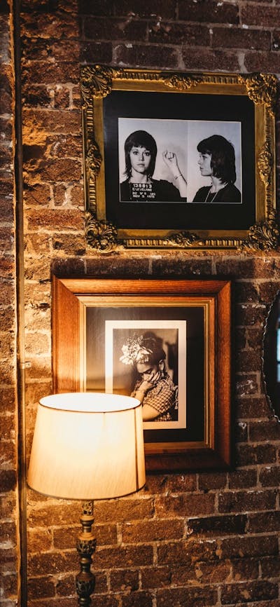 Brick wall with portraits in dining area